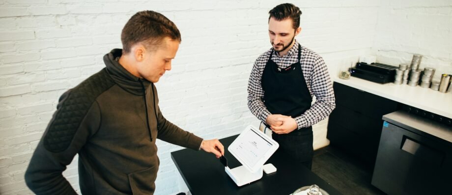 man looking at white digital device