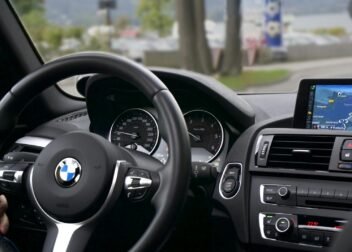 Elegant BMW car interior showcasing navigation screen, speedometer, and steering wheel.