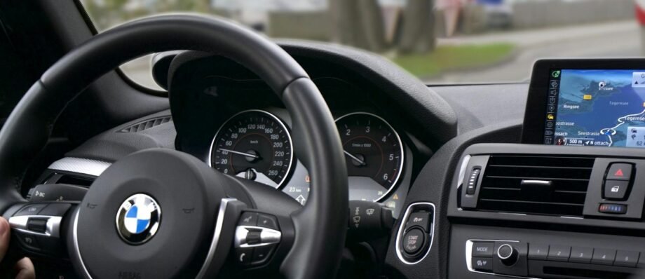 Elegant BMW car interior showcasing navigation screen, speedometer, and steering wheel.