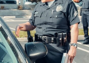 A police officer conducts a traffic stop in a suburban neighborhood, ensuring public safety.