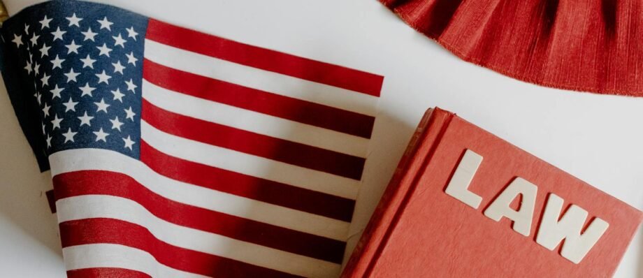 Patriotic scene with American flag and law book on a white background, symbolizing freedom and democracy.