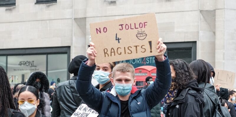 people in blue jacket holding blue banner