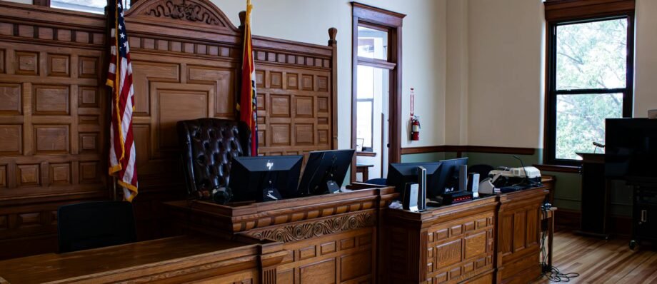 Interior view of an American courthouse in Kirksville, Missouri, featuring a judge's desk and flags.
