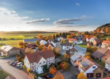 Charming aerial view of a rural village in autumn with vivid colors and clear skies.