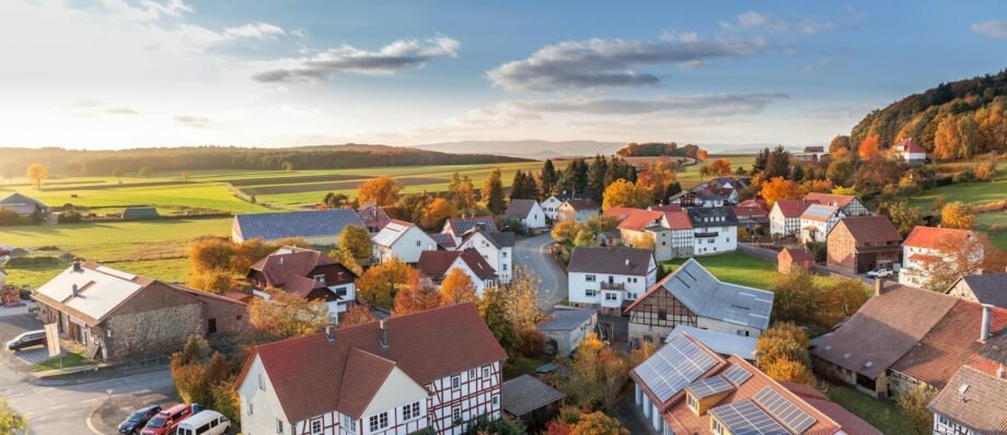 Charming aerial view of a rural village in autumn with vivid colors and clear skies.
