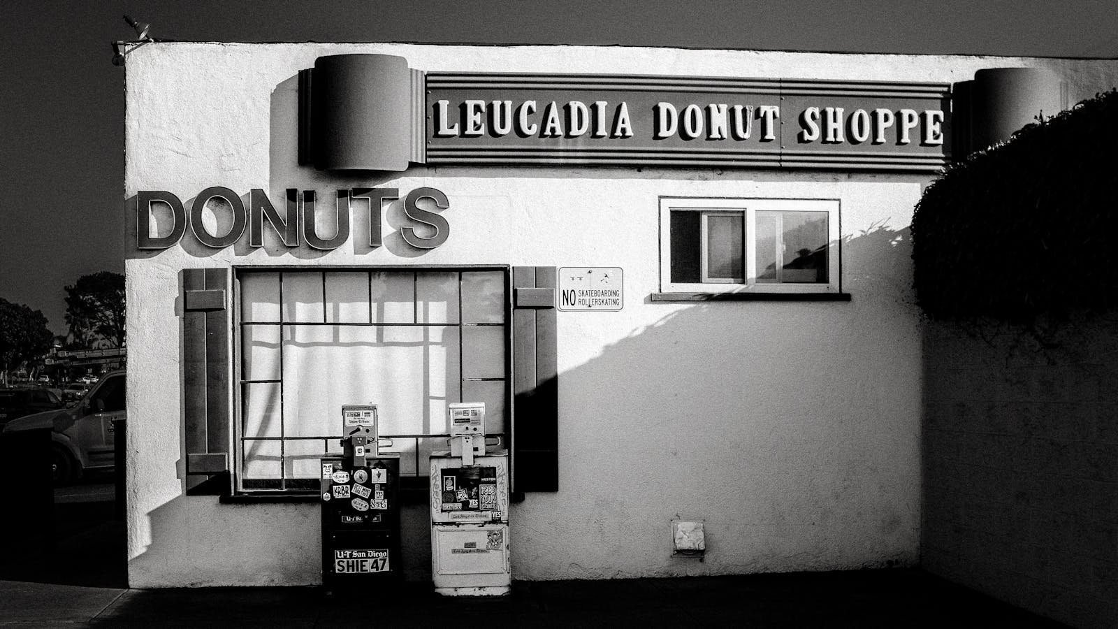 Classic black and white photo of Leucadia Donut Shoppe exterior, featuring retro signage in California.