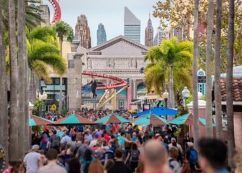 Vibrant scene with a large crowd at Universal Studios Orlando, capturing the lively theme park atmosphere.