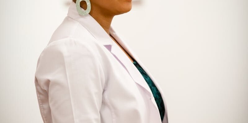 Portrait of a smiling female doctor in a white coat, exuding professionalism and confidence.