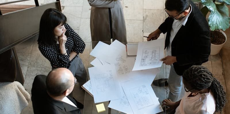 A team of professionals engage in a business meeting in a sleek, modern office setting.