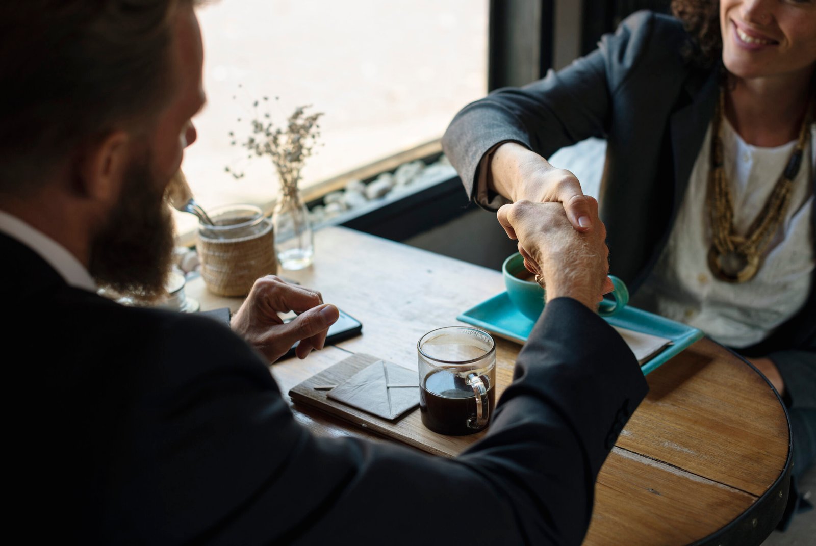 A client shaking hands with an attorney after a consultation